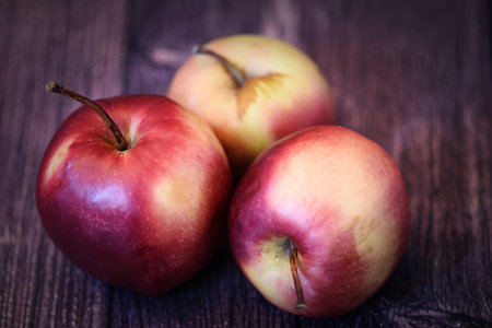 Red apples on a wooden background. close-up. selective focus.の写真素材