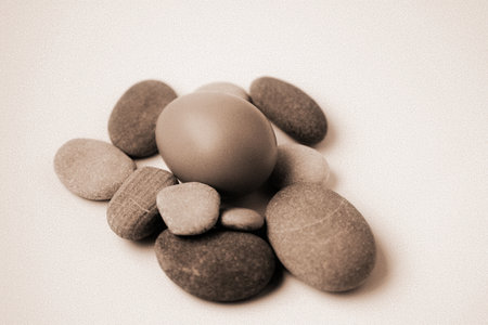 Easter eggs and pebbles on white background. Toned.の写真素材