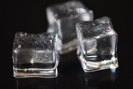 Ice cubes on black background. Shallow depth of field. selective focus.の写真素材
