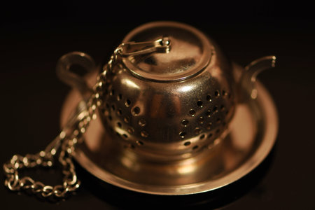 Vintage brass teapot on a black background. selective focus.の写真素材