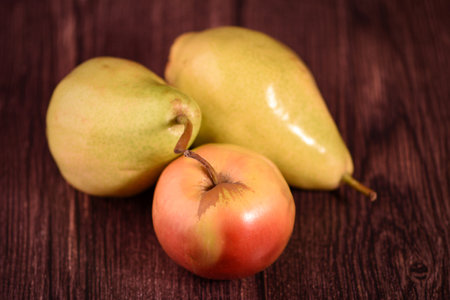 Ripe pear and apples on a wooden background. Toned.の写真素材