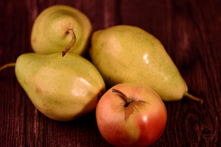 Ripe pears and apples on a dark wooden background. Toned.の写真素材