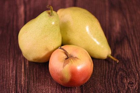 Ripe pear and apples on a wooden background. Toned.の写真素材