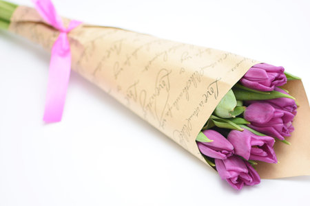 Bouquet of purple tulips on white background with copy spaceの写真素材