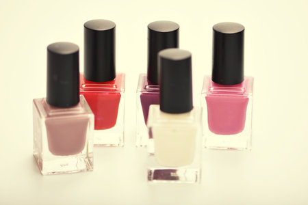 Nail polish bottles isolated on white background. selective focus. Toned.の写真素材