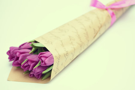 Bouquet of purple tulips on white background with copy spaceの写真素材