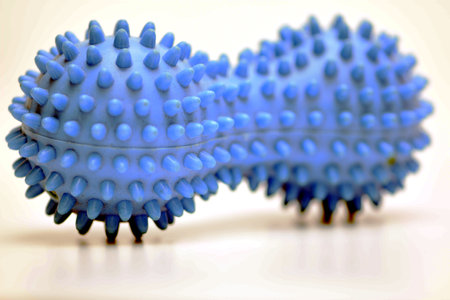 Blue plastic massage brush on a white background. close-up.の写真素材
