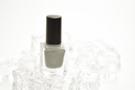 Nail polish bottle on ice cubes background, clipping path included.の写真素材