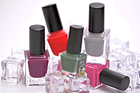 Group of nail polishes with ice cubes on a white background.の写真素材