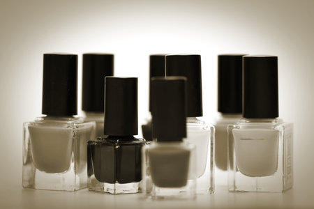 Nail polish bottles on white background. Shallow depth of field. Toned.の写真素材