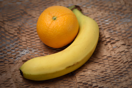 Banana and orange on a wooden background. selective focus.の写真素材