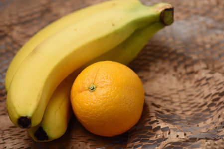 banana and orange on a wooden background. selective focus.の写真素材