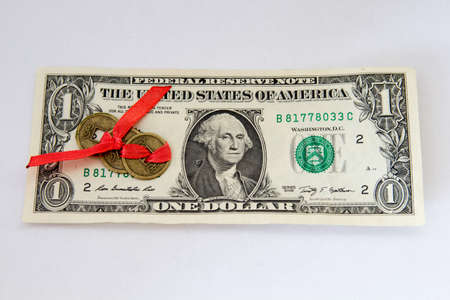 One dollar and Chinese coin on a white backgroundの写真素材