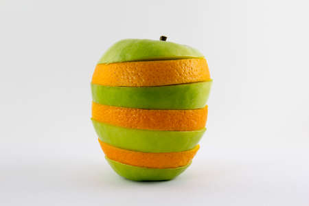 Mixed apple and orange isolated on white background conceptの写真素材