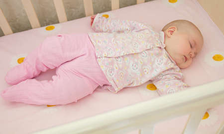 Very nice sweet baby sleeping in cribの写真素材