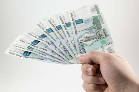 Hand with Russian rubles on a white background