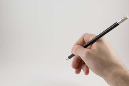 Hand with a pencil on a white backgroundの写真素材