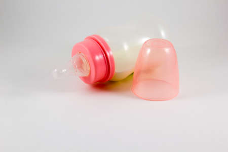 Baby bottle with milk on a white backgroundの写真素材