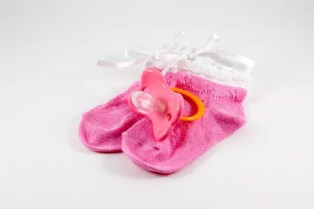 Booties and pacifier on a white background