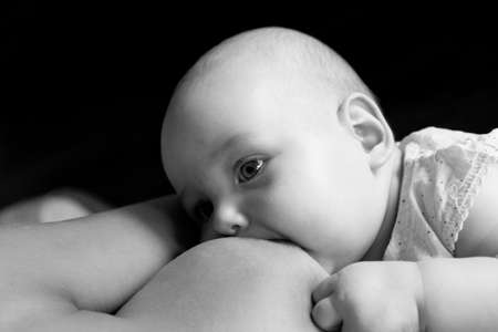Mother breast feeding a newborn. Baby sucklesの写真素材