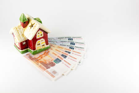 House and money on a white backgroundの写真素材