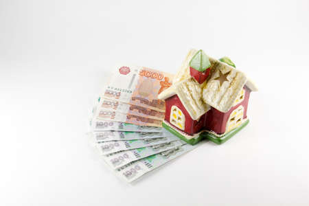 House and money on a white backgroundの写真素材