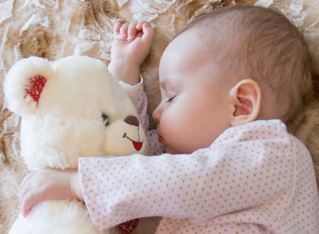 Baby sleeping with teddy bear