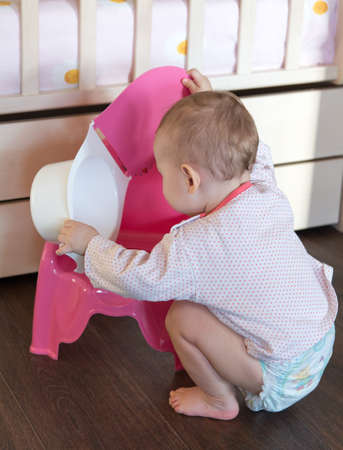 Toddler playing with baby pottyの写真素材