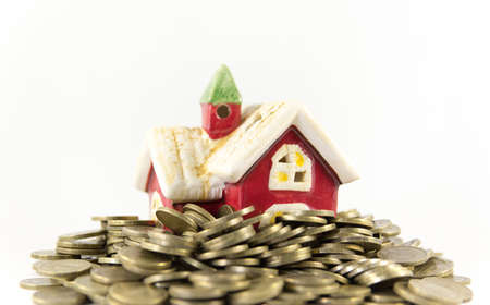House and many coins on a white backgroundの写真素材