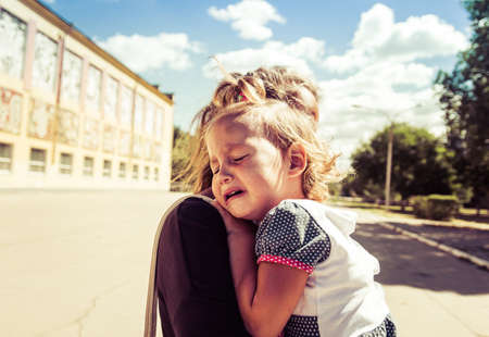 Mom soothes baby. The baby is cryingの写真素材