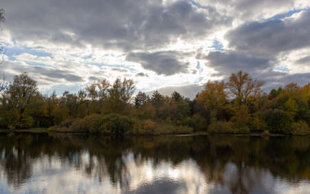 Forest lake landscape in autumn in cloudy weatherの写真素材