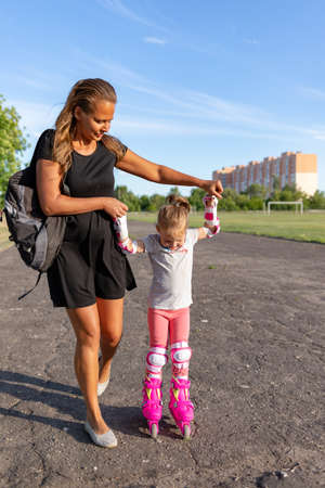 Child learns to roller skate. Roller skatingの写真素材
