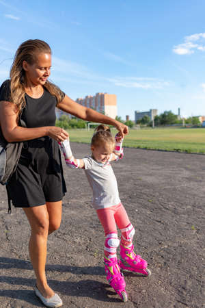 Child learns to roller skate. Roller skatingの写真素材