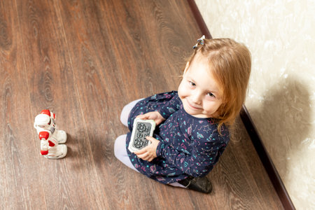 the child controls the robot from the remote controlの写真素材