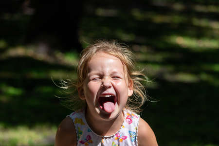 the child is crying and laughing, the child is hystericalの写真素材