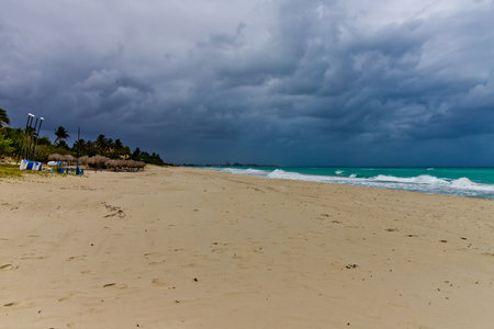 blue clouds and big waves during storm, empty beachの写真素材