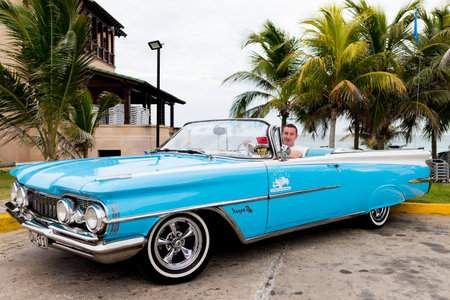 Varadero, Cuba - May 20, 2021: Oldsmobile Super 88 1959 in Cuba. Driver driving a convertibleのeditorial素材