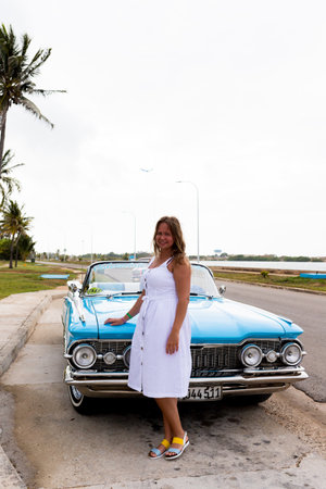 Varadero, Cuba - May 20, 2021: Oldsmobile Super 88 1959 in Cuba. Young woman on the hood of a convertibleのeditorial素材