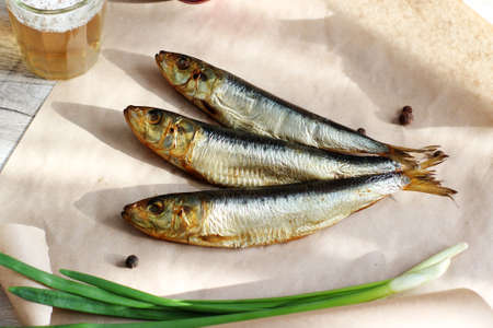 smoked fish cut bow and glass of beer on a table
