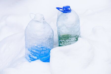  Winter car wash glass liquid in the snow. Non-freezing liquid for washing car glass in winter. Car non-freezing fluid in frost on snow. Blue liquid in frost during day.の写真素材