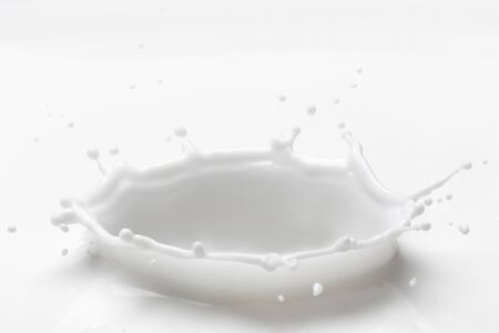 Milk splash with high speed photography.Pouring milk splash isolated on white backgroundの写真素材