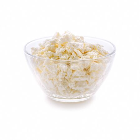 Plate with fresh cottage cheese on a white background. Very useful dairy product for the development of the child's body.の写真素材