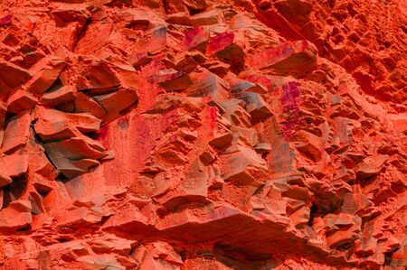 Surface with a texture of red Martian stone. Designer background for interiors. Stone surface of a...
