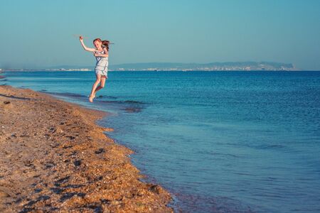 A happy child, playing with a toy airplane, runs along the sandy beach of the sea against the blue summer sky and wants to fly away into his dreams.
の写真素材