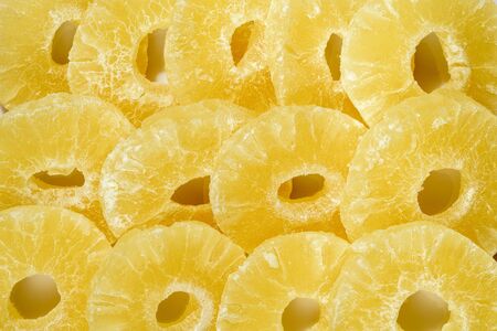 Yellow pineapple sweets, cut into round slices.の写真素材