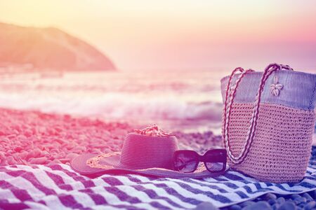 Rest on the sea on a warm summer day. Resting place on a pebble beach. Summer vacation concept with...