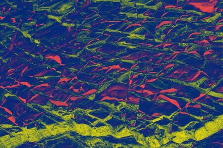 Colorful (red, pink, yellow and purple) stone mosaic tiles on the wall as a background or texture. An abstract composition.の写真素材