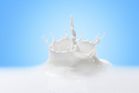 Creamy Milk Splash Over Blue Background.Close up of a milk splash on blue background.の写真素材