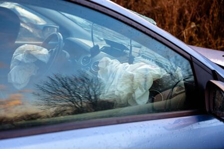 Operated airbags in a broken car. Concept of safe driving. Airbags save lives.