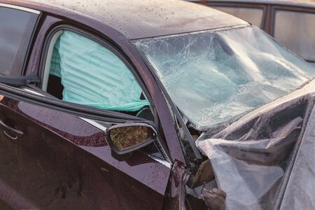 The broken field of a head-on collision car, with airbags deployed.